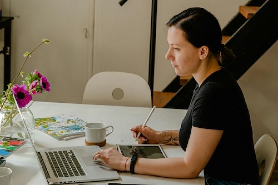 Woman at a laptop looking at design. 