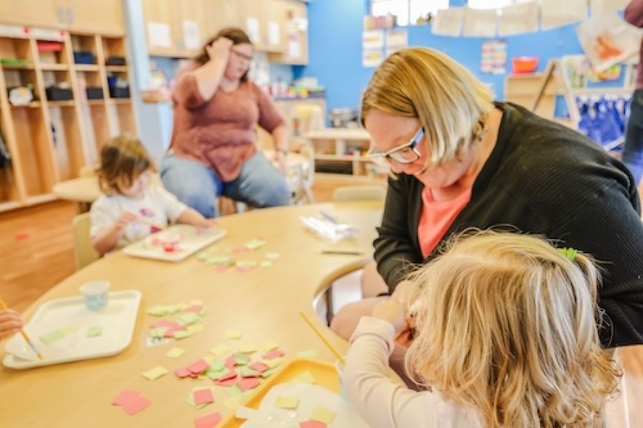 Woman working with small children. 