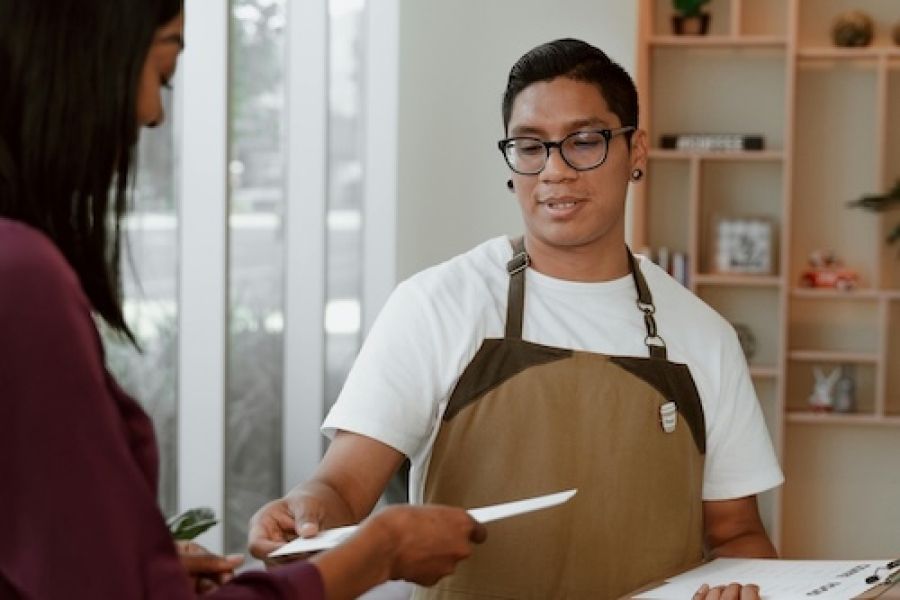 Two people talking in a restaurant setting. 