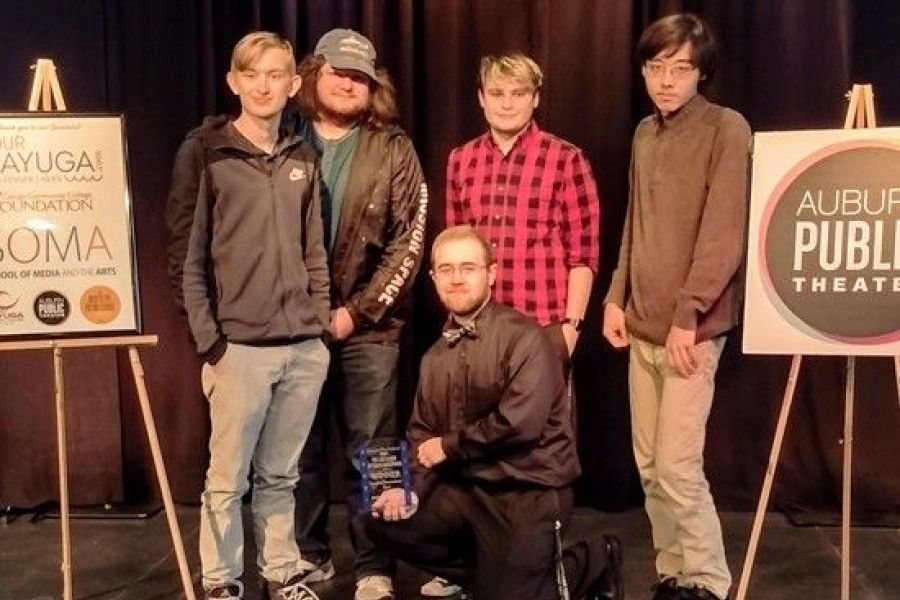 Students pose with award on stage