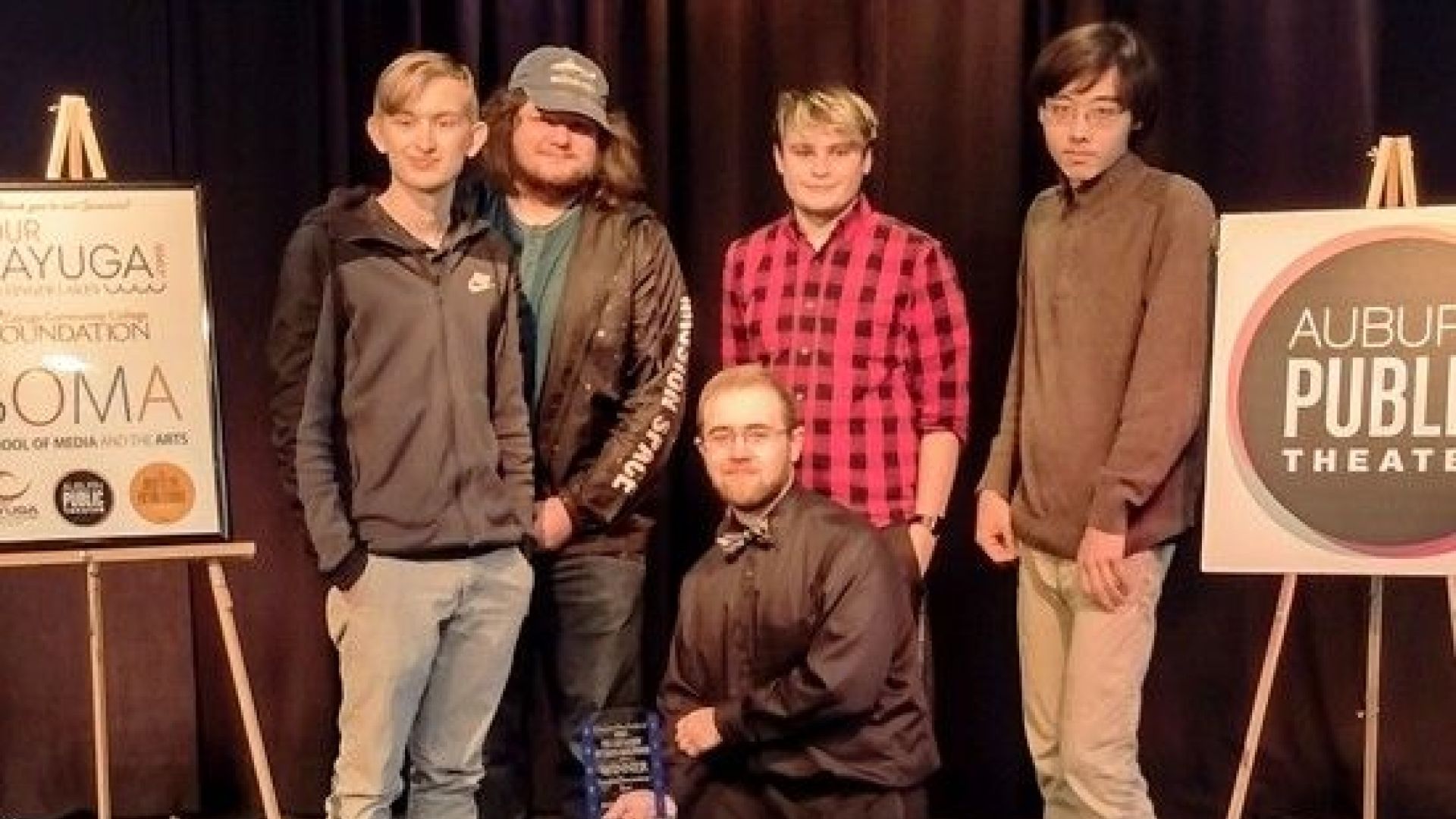 Students pose with award on stage