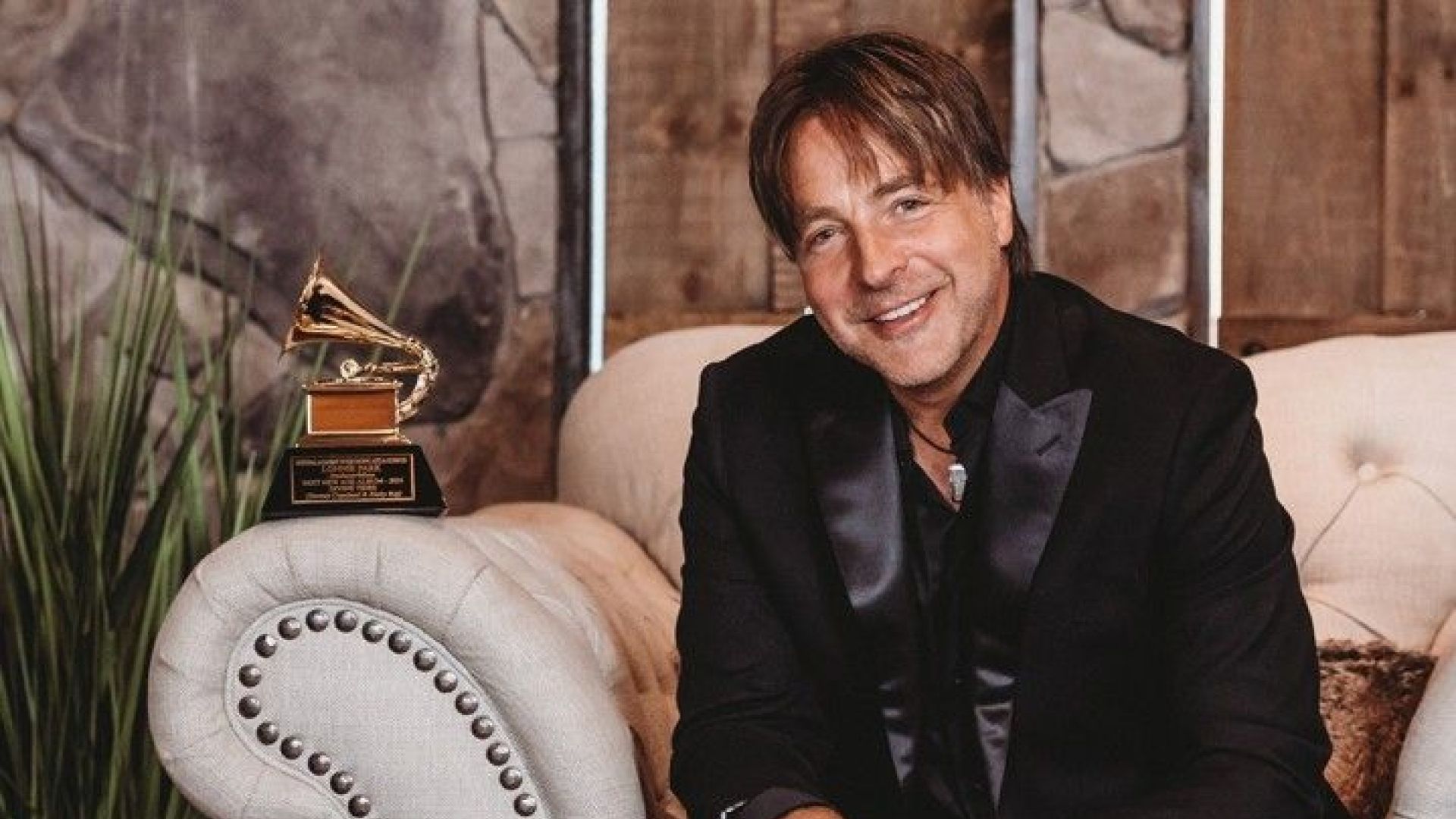 Lonnie Park sitting with a Grammy award