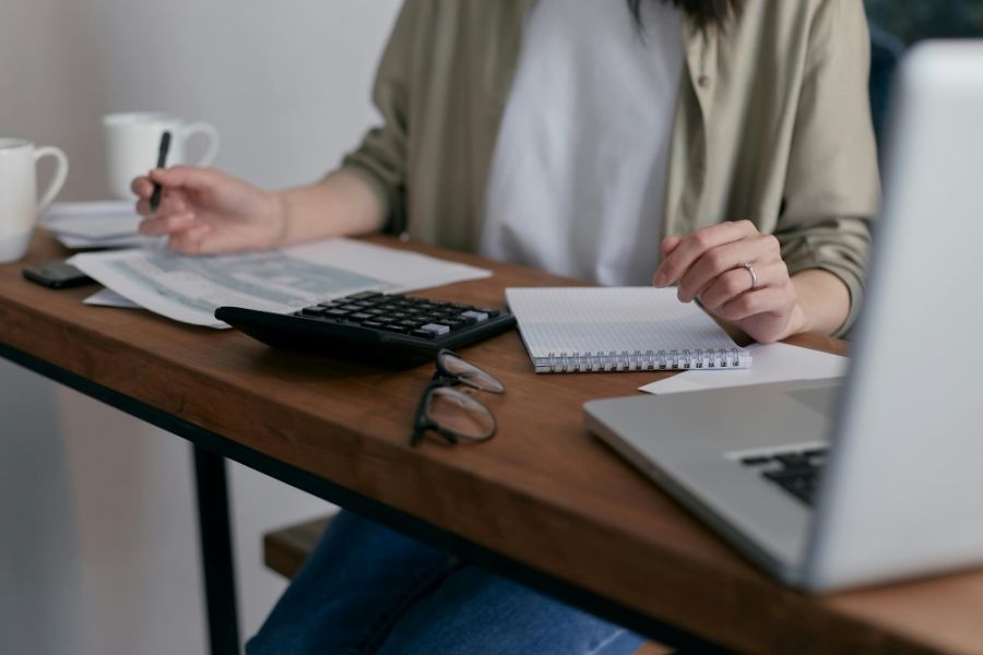 Person at their desk and looking at some papers. 