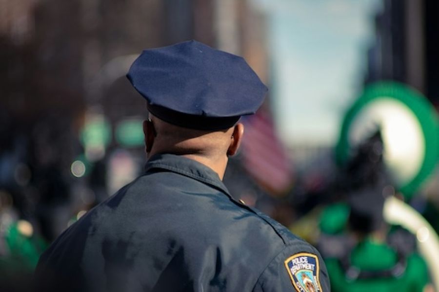 Back of the head of a police officer. 